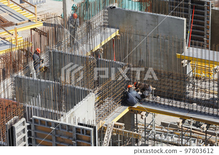 builder in orange helmet works, construction of multi-storey building or shopping center in city builder in orange helmet works, construction of multi-storey building or shopping center in city 97803612