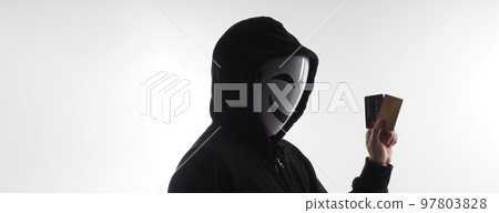 Hacker man and credit cards in hand. Represent credit cards personal data stolen by anonymous man in Black hood shirt. Credit cards data security and Cyber crime digital. Money transection unsecured. Hacker man and credit cards in hand. Represent credit cards personal data stolen by anonymous man in Black hood shirt. Credit cards data security and Cyber crime digital. Money transection unsecured. 97803828