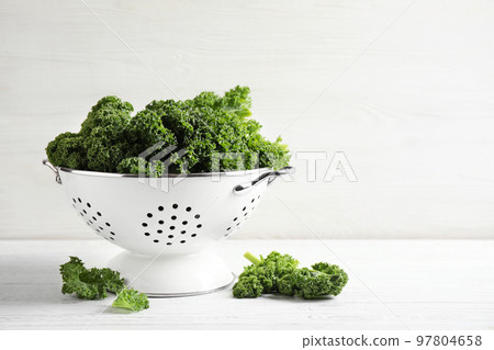 Fresh kale leaves on white wooden table. Space for text Fresh kale leaves on white wooden table. Space for text 97804658