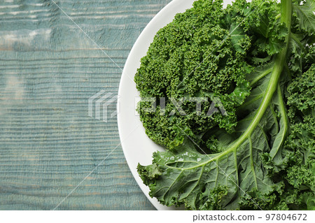 Fresh kale leaves on light blue wooden table, top view. Space for text Fresh kale leaves on light blue wooden table, top view. Space for text 97804672