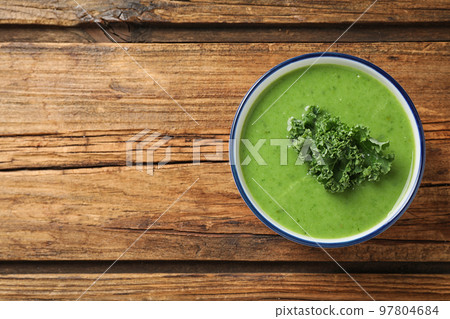 Tasty kale soup on wooden table, top view. Space for text Tasty kale soup on wooden table, top view. Space for text 97804684