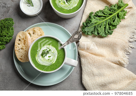 Tasty kale soup served on grey table, flat lay Tasty kale soup served on grey table, flat lay 97804685