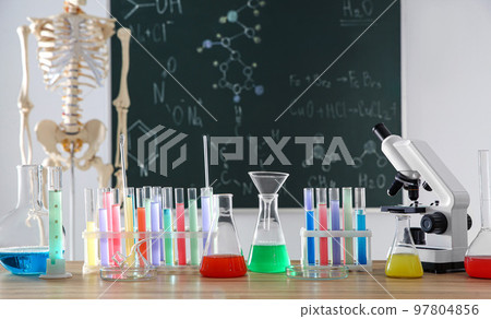 Different chemistry glassware on table in classroom Different chemistry glassware on table in classroom 97804856