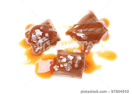 Delicious salted caramel with sauce on white background, top view 97804950