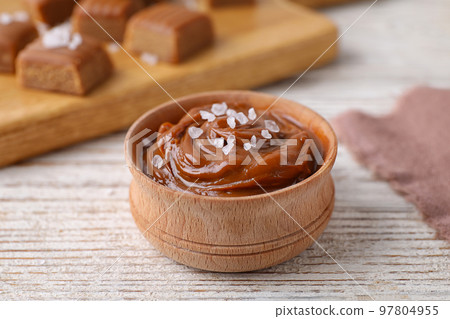 Delicious salted caramel on white wooden table 97804955