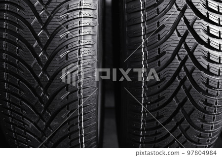 Car tires as background, closeup. Auto store 97804984
