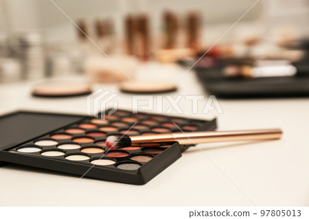 Brush and eyeshadow palette on professional makeup artists workplace, closeup Brush and eyeshadow palette on professional makeup artists workplace, closeup 97805013
