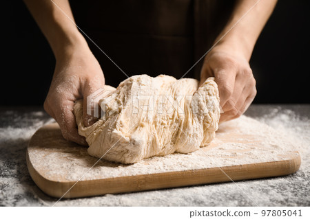 Woman with dough at grey table, closeup. Making pasta Woman with dough at grey table, closeup. Making pasta 97805041