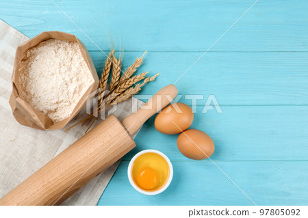 Flat lay composition with raw eggs on light blue wooden table. Baking pie Flat lay composition with raw eggs on light blue wooden table. Baking pie 97805092