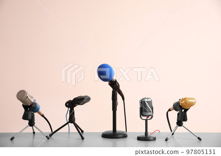 Different microphones on light grey table. Journalist's work 97805131