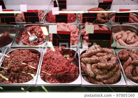 Fresh raw ground meat and sausages in refrigerator at wholesale market 97805160