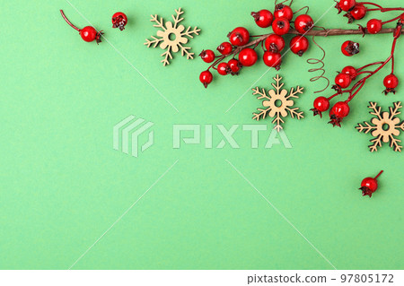 Winter composition with decorative branches on green background, flat lay. Space for text 97805172