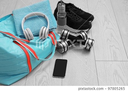 Sports bag and gym stuff on wooden floor Sports bag and gym stuff on wooden floor 97805265