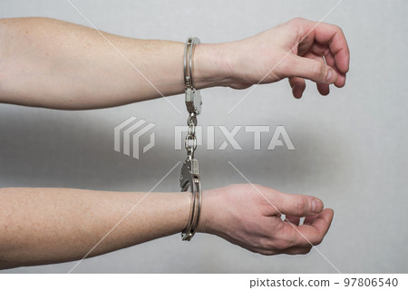 Hands in handcuffs. Prisoner or arrested man ,closeup of hands in handcuffs 97806540