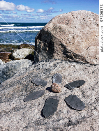 A flower of black stone slabs on the shore of the Baltic Sea. Latvia A flower of black stone slabs on the shore of the Baltic Sea. Latvia 97806578