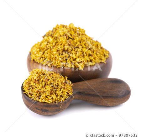Osmanthus tea in wooden bowl and spoon, isolated on white background. Dry flowers of Osmanthus fragrans. Osmanthus tea in wooden bowl and spoon, isolated on white background. Dry flowers of Osmanthus fragrans. 97807532