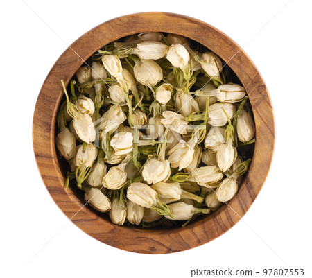Dry jasmine flowers in wooden bowl, isolated on white background. Jasmine flowers tea. Herbal tea. Top view. 97807553