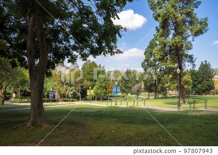 Los Angeles, USA. September 20, 2022. Scenic view of trees growing on green grassy landscape with sky in the background at formal garden in the UCLA campus Los Angeles, USA. September 20, 2022. Scenic view of trees growing on green grassy landscape with sky in the background at formal garden in the UCLA campus 97807943