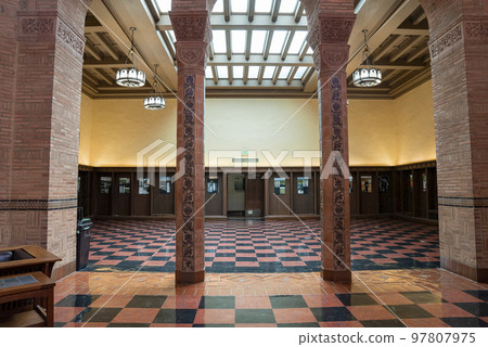 Los Angeles, USA. September 20, 2022. Chandeliers hanging on ceiling over tiled floor inside the UCLA seen through patterned columns at entrance Los Angeles, USA. September 20, 2022. Chandeliers hanging on ceiling over tiled floor inside the UCLA seen through patterned columns at entrance 97807975