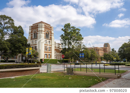 Los Angeles, USA. September 20, 2022. View of grassy land and trees growing on street with university buildings in the background under cloudy sky at UCLA campus Los Angeles, USA. September 20, 2022. View of grassy land and trees growing on street with university buildings in the background under cloudy sky at UCLA campus 97808020