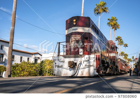 Santa Cruz, USA. September 20, 2022. Low angle view of vintage red tram with text moving at historic Santa Cruz Beach Boardwalk with clear blue sky in the background Santa Cruz, USA. September 20, 2022. Low angle view of vintage red tram with text moving at historic Santa Cruz Beach Boardwalk with clear blue sky in the background 97808060