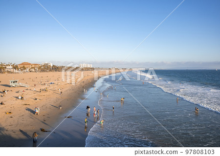 Los Angeles, USA. September 20, 2022. Aerial view of people enjoying at Venice beach and scenic view of waves splashing on shore with clear blue sky in background during sunset Los Angeles, USA. September 20, 2022. Aerial view of people enjoying at Venice beach and scenic view of waves splashing on shore with clear blue sky in background during sunset 97808103