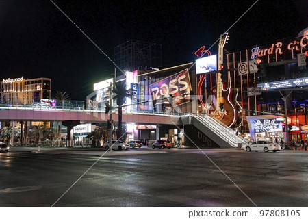 Las Vegas, USA. September 16, 2022. Cars moving on road under bridge by Hard Rock Cafe. View of tourist attraction in famous Las Vegas city with dark sky in background during night. Las Vegas, USA. September 16, 2022. Cars moving on road under bridge by Hard Rock Cafe. View of tourist attraction in famous Las Vegas city with dark sky in background during night. 97808105