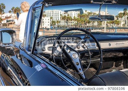 Los Angeles, USA. September 20, 2022. Close-up of steering wheel in empty retro black convertible car displayed at classic car exhibition on Santa Monica pier during sunny day Los Angeles, USA. September 20, 2022. Close-up of steering wheel in empty retro black convertible car displayed at classic car exhibition on Santa Monica pier during sunny day 97808106
