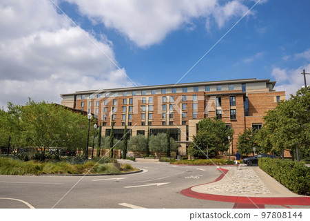 Los Angeles, USA. September 20, 2022. Road with arrow markings leading towards UCLA building with cloudy sky in the background during sunny day 97808144