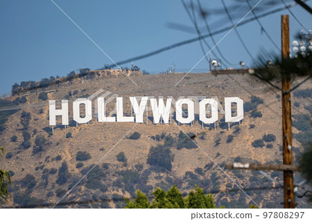 Los Angeles, USA. September 20, 2022. Beautiful view of Hollywood sign on Mount Lee seen through electricity pole on sunny day with clear blue sky in the background Los Angeles, USA. September 20, 2022. Beautiful view of Hollywood sign on Mount Lee seen through electricity pole on sunny day with clear blue sky in the background 97808297