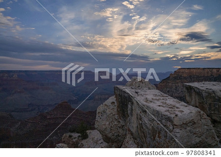 Scenic View Of Rock Formations And Majestic Mountains under Cloudy Sky At Grand Canyon National Park In Arizona During Sunset 97808341