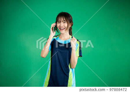 Excited female table tennis athlete calling using mobile phone Excited female table tennis athlete calling using mobile phone 97808472
