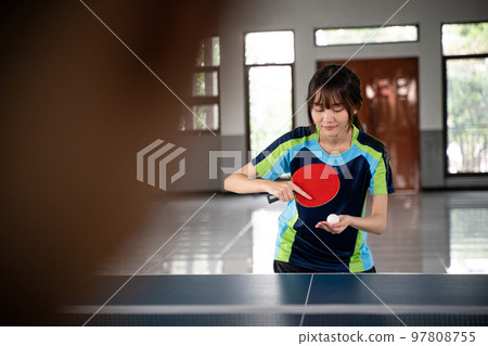 female athlete holding ball serving against opponent 97808755