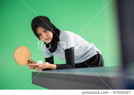 Young asian girl in hijab playing table tennis Young asian girl in hijab playing table tennis 97808887