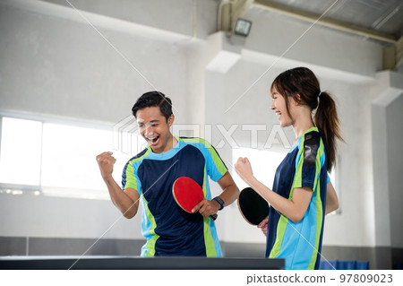 Two ping pong players compete with fists while scoring 97809023