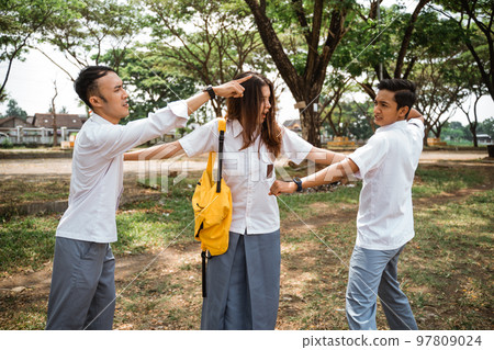 A girl between two high school boys in conflict A girl between two high school boys in conflict 97809024
