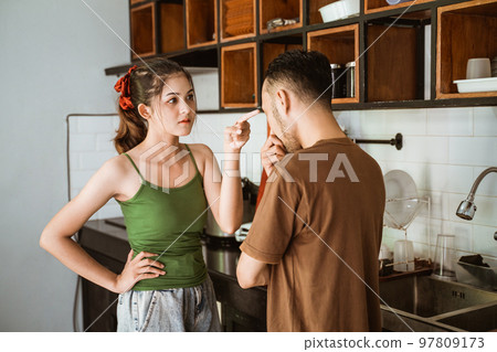 beautiful wife angry at husband while fighting in kitchen background 97809173