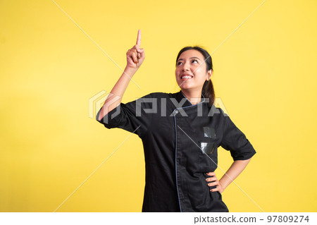 excited asian female chef with finger pointing up excited asian female chef with finger pointing up 97809274