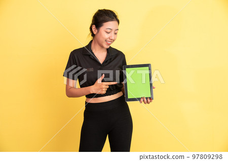 woman looking at tablet with finger pointing showing tablet screen woman looking at tablet with finger pointing showing tablet screen 97809298