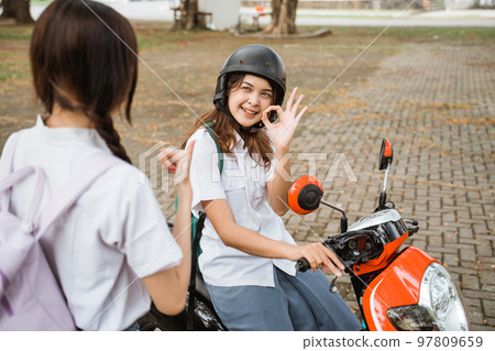 High school student girl wearing helmet with okay hands gesture High school student girl wearing helmet with okay hands gesture 97809659