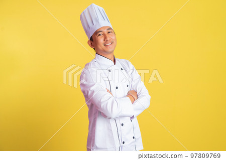 asian male chef smiling with hands crossed on isolated background asian male chef smiling with hands crossed on isolated background 97809769