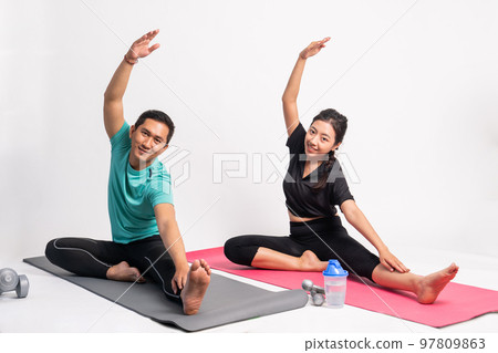 asian couple doing yoga practice exercise with stretching movements asian couple doing yoga practice exercise with stretching movements 97809863