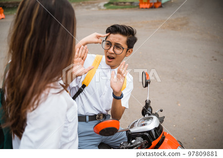 Male student in glasses scared when threatened by a girl 97809881