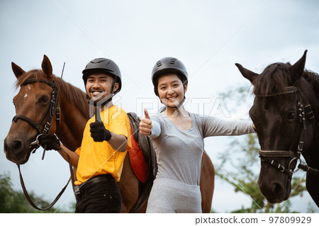 two equestrian athletes ride horses and start training 97809929