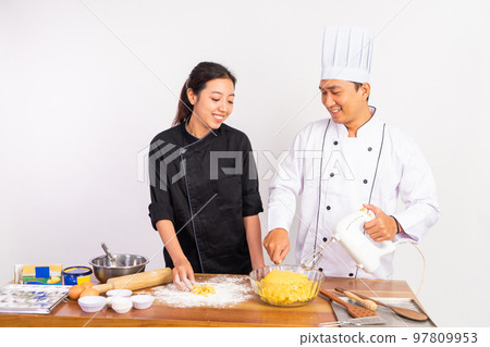 male and female chefs making cookie dough and using mixer male and female chefs making cookie dough and using mixer 97809953