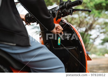 Close up of a student's hand holding a key motorcycle 97810012