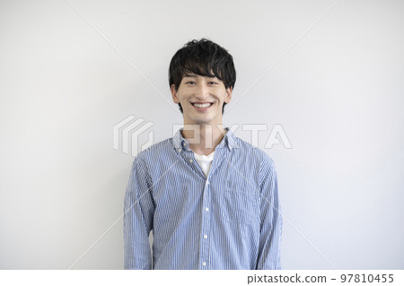 A young man looking at the camera and smiling - Stock Photo [97810455 ...