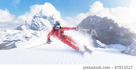 Rapid descent at high speed. Skier skiing on a sunny day in high mountains. Downhill. Ski skiing in mountains. Skiing descent at high speed. Snow dust 97813527