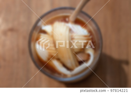 Glass of americano mixed with coconut blur background 97814221