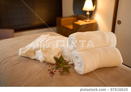 Gowns and towels on the bed in the beauty salon 97816620
